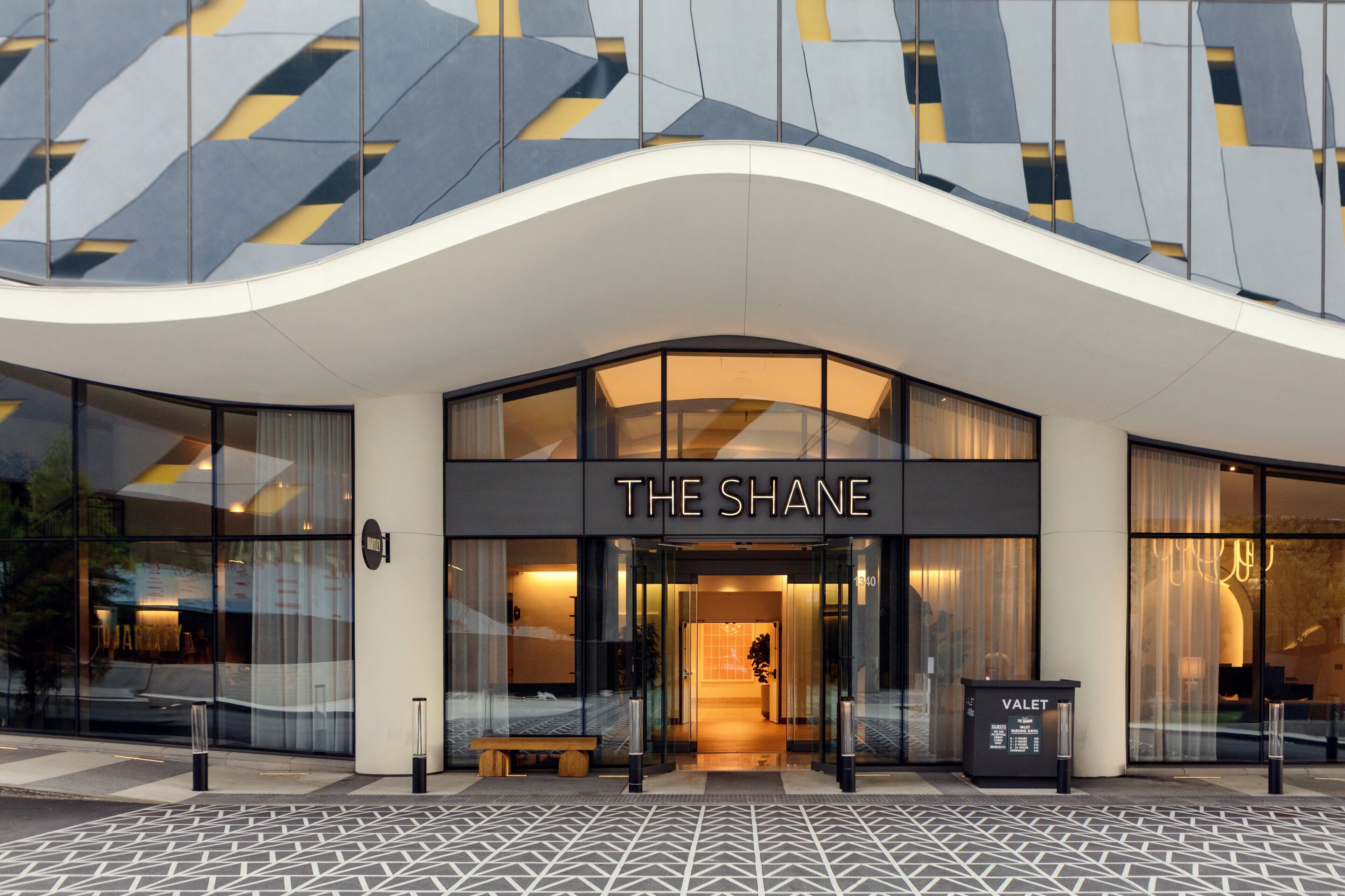 Street entrance and curved facade of Kimpton Shane in Midtown Atlanta