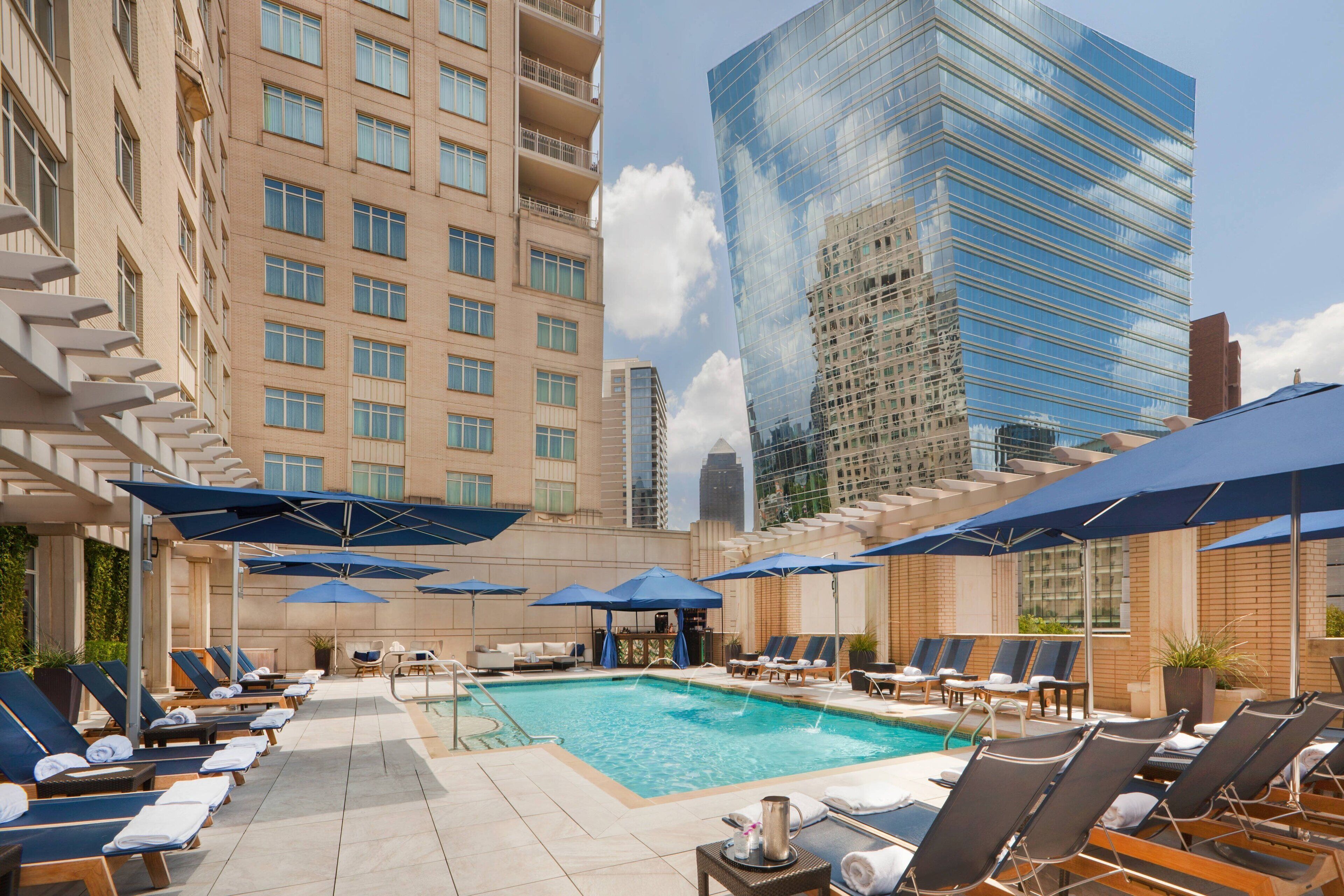 Outdoor pool surrounded by the Uptown skyline at The Ritz-Carlton Dallas