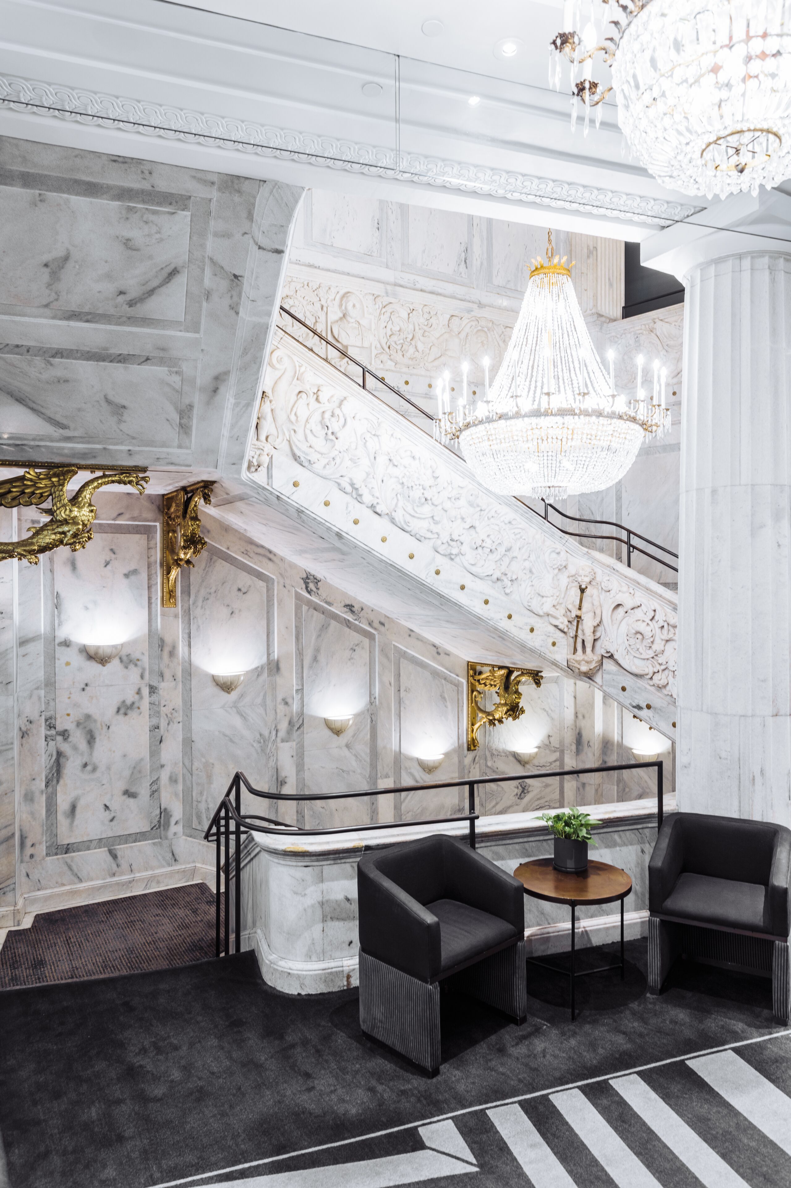 Marble staircase and chandelier inside The Candler Hotel Atlanta