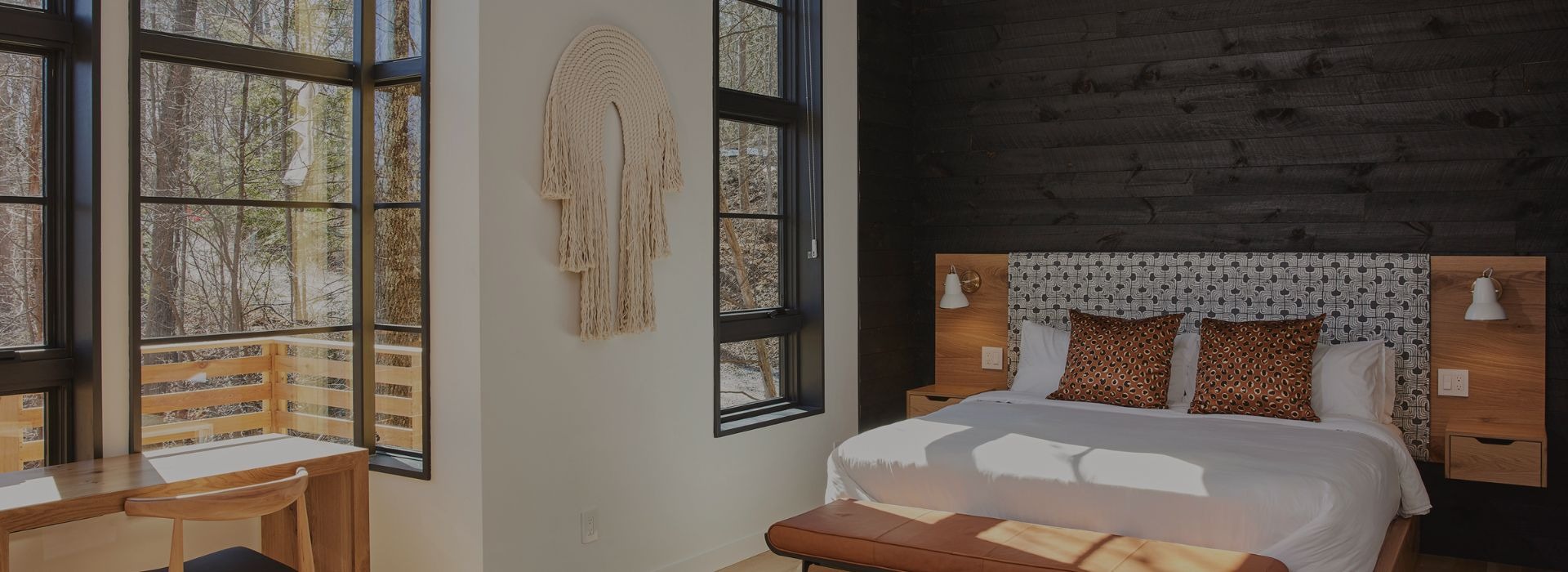 Guest bedroom with bench at Woodstock Way Hotel