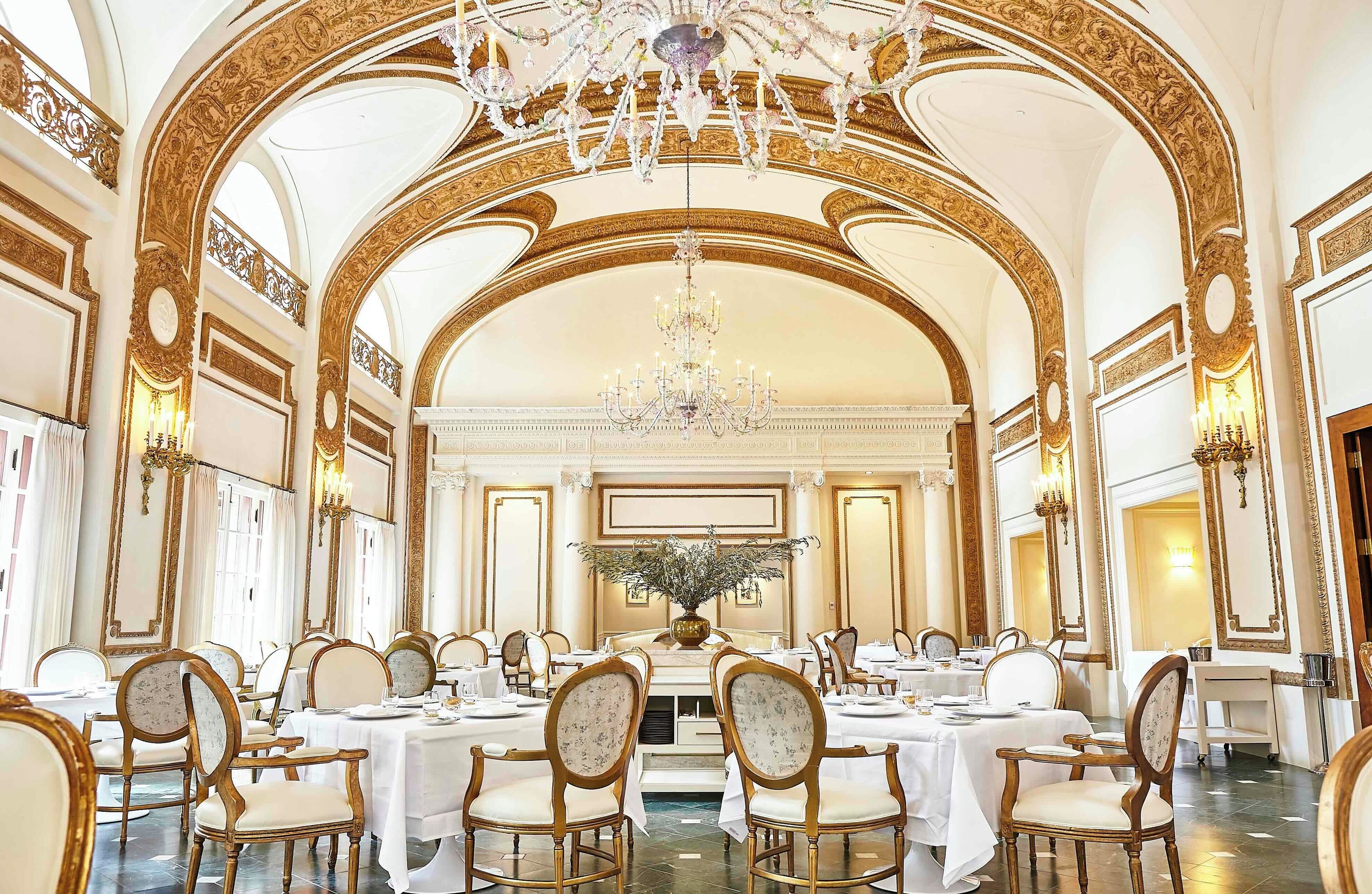 Ornate dining room with chandeliers at The Adolphus Dallas