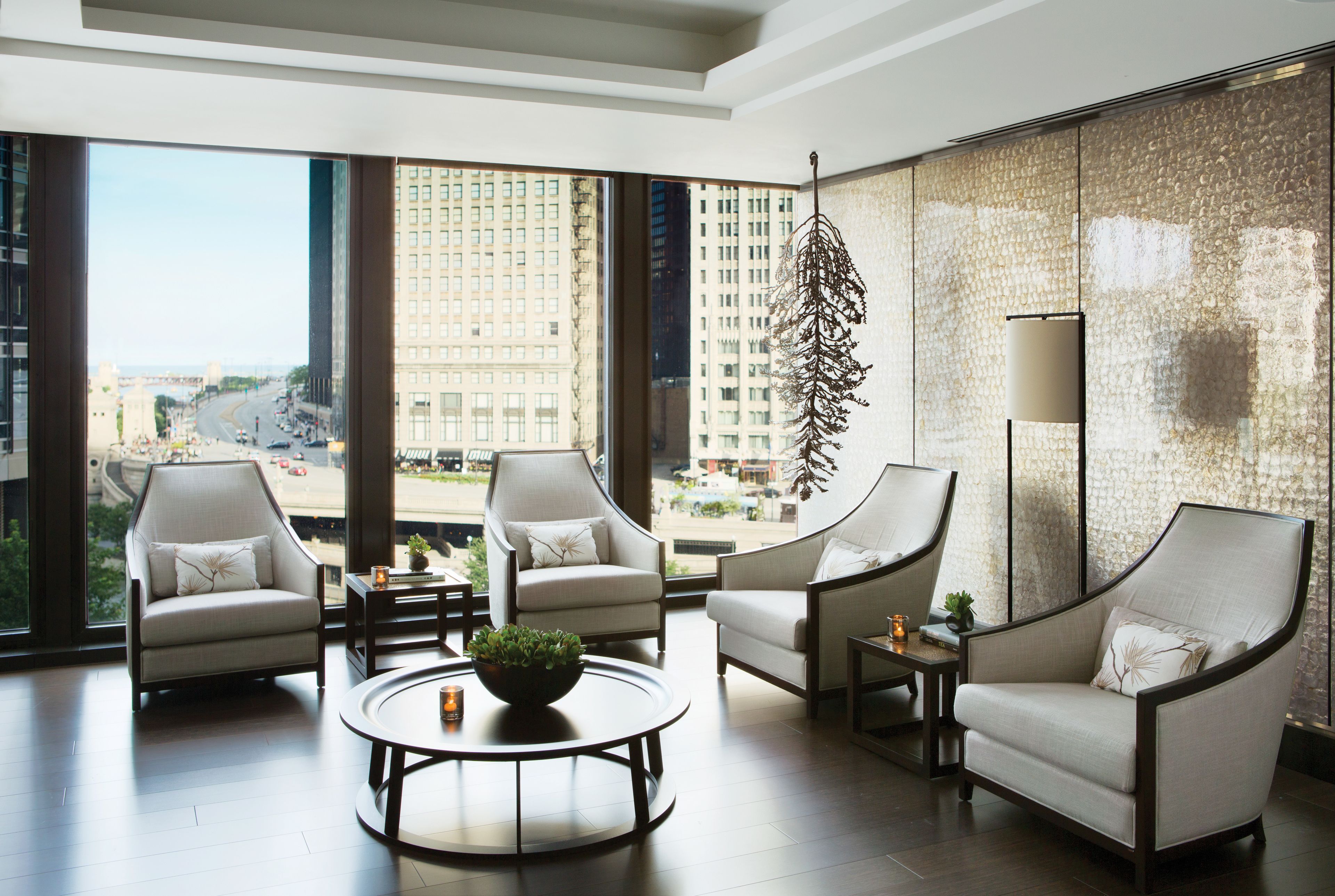 A Langham Chicago guestroom sitting area with city views; category may differ from the entry room