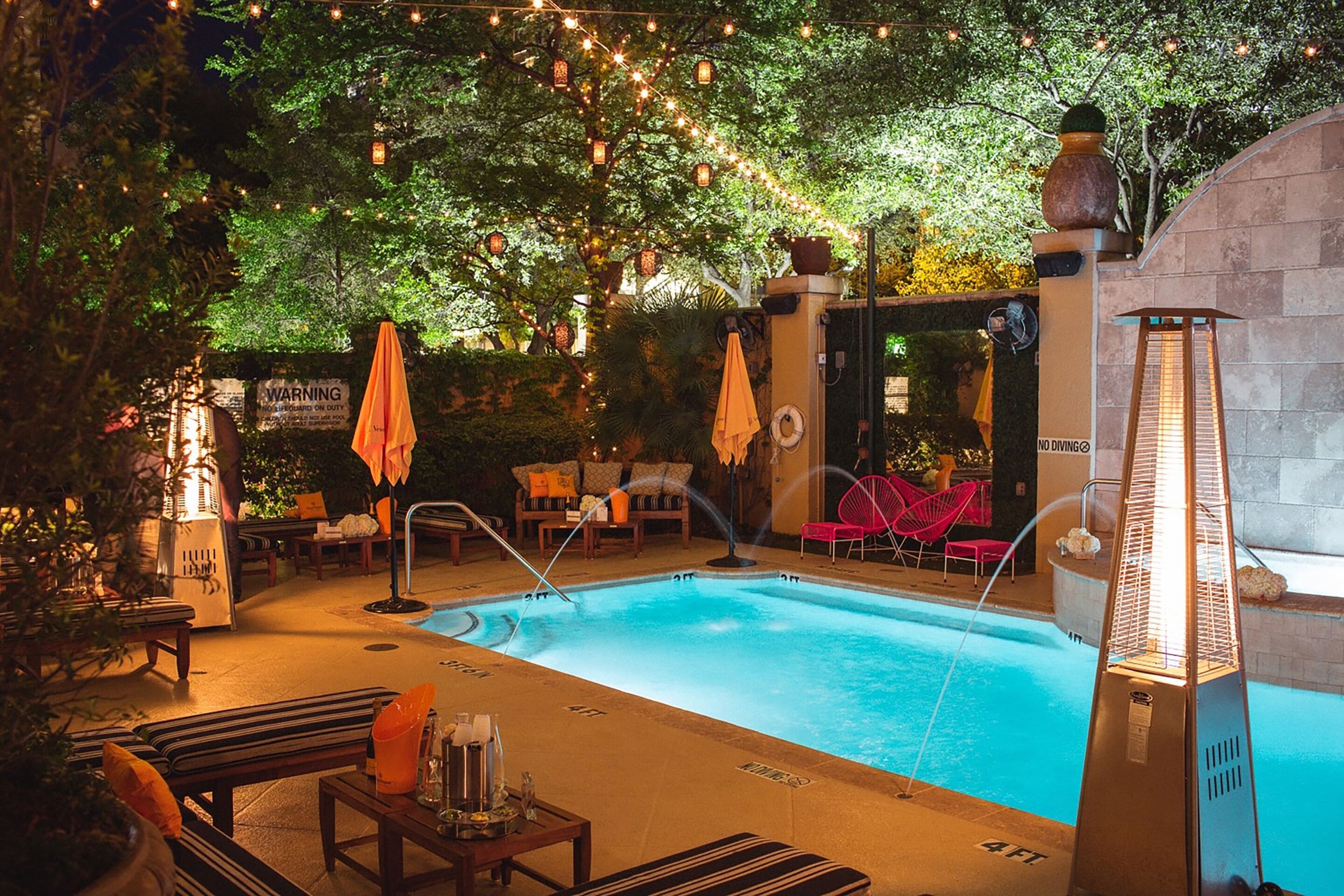 Hotel ZaZa Dallas pool with loungers and evening string lights