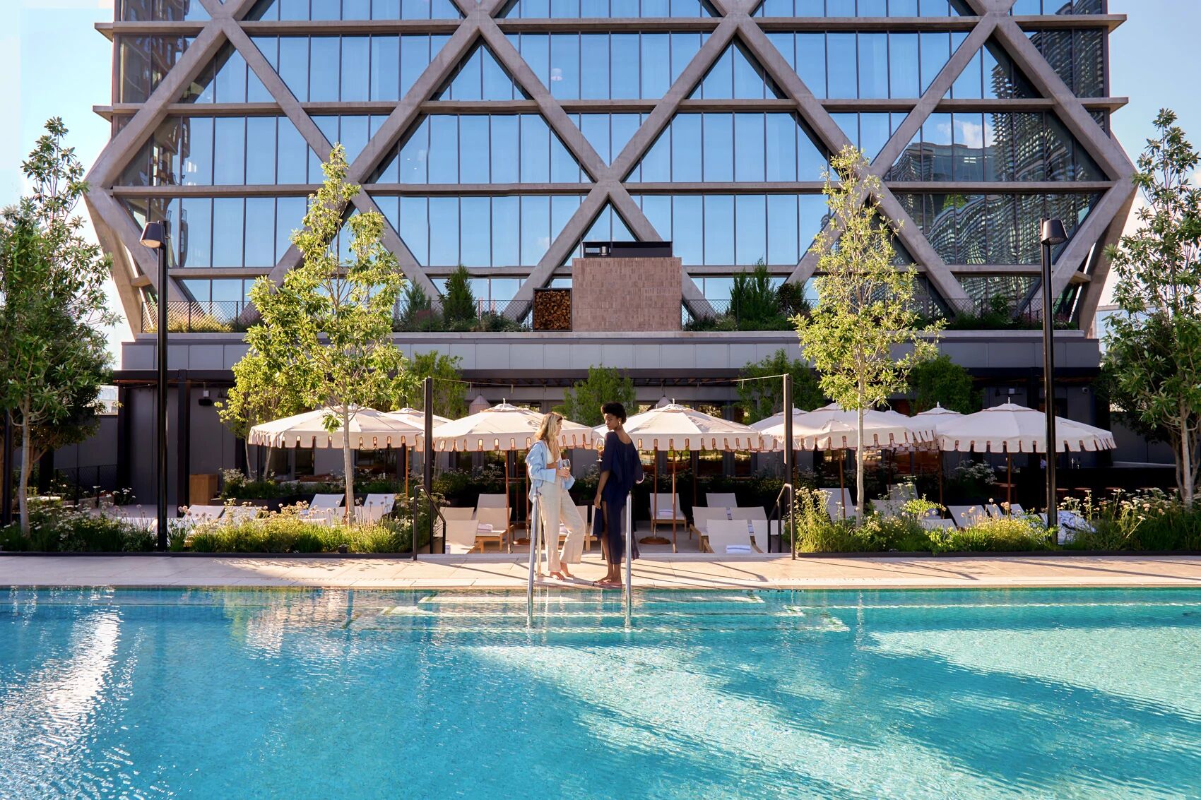 FORTH Atlanta’s outdoor pool beneath its geometric hotel facade